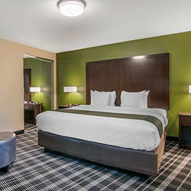 King-Efficiency-Suite King Suite Bedroom at Quality Inn & Suites Albany